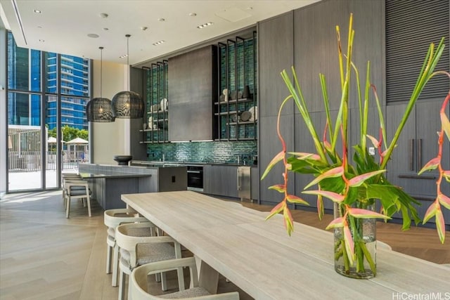 interior space with backsplash and expansive windows