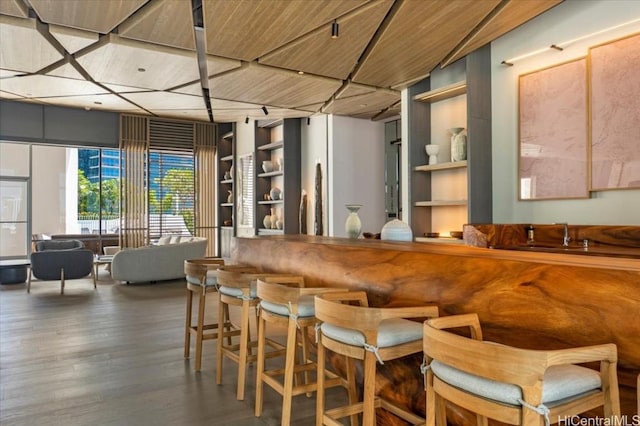 bar with built in shelves, hardwood / wood-style flooring, and wooden ceiling