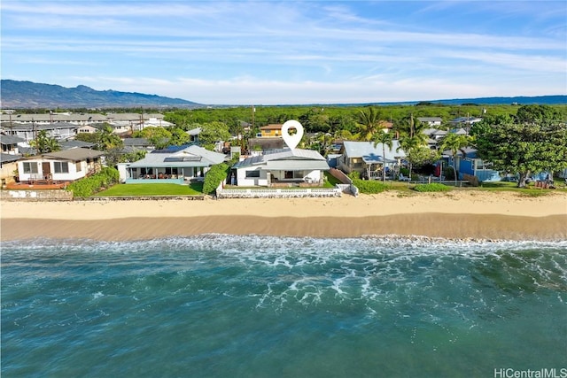 aerial view with a water and mountain view and a beach view