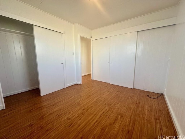 unfurnished bedroom featuring hardwood / wood-style floors and a closet