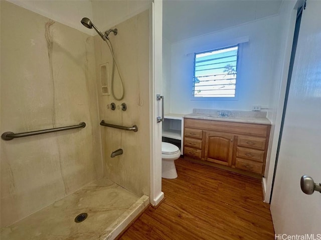 bathroom featuring hardwood / wood-style flooring, vanity, toilet, and walk in shower