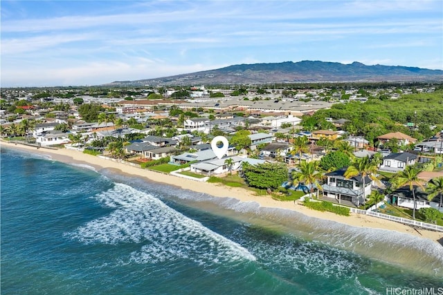 aerial view with a water and mountain view and a view of the beach