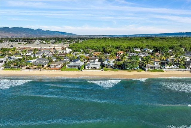 drone / aerial view with a beach view and a water and mountain view