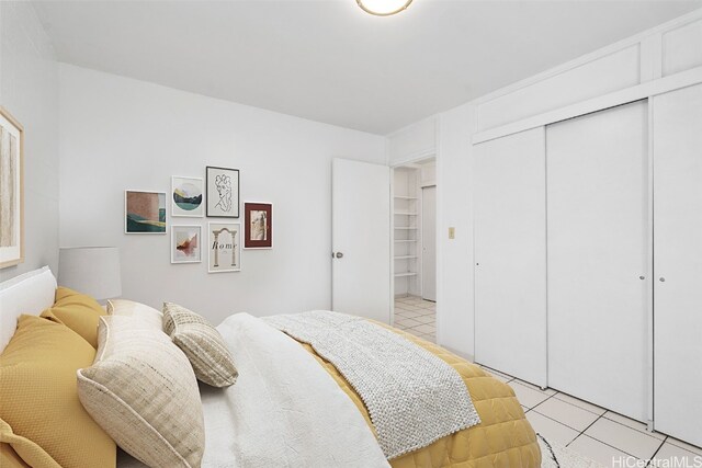 tiled bedroom with a closet