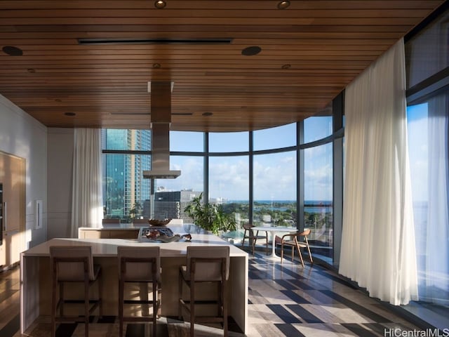 dining space featuring floor to ceiling windows, wood ceiling, and a wealth of natural light