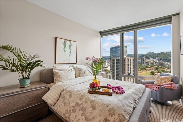 carpeted bedroom with floor to ceiling windows