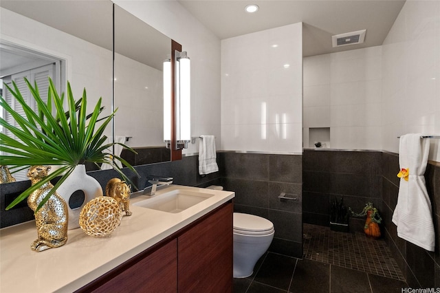 1108 Auahi St Unit 2208, Honolulu, HI 96814 - bathroom with tile walls, tile patterned floors, vanity, toilet, and recessed lighting