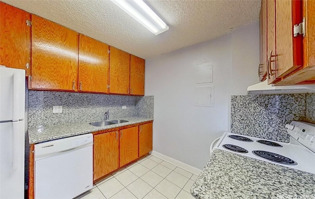 kitchen featuring decorative backsplash, a textured ceiling, white appliances, sink, and light tile patterned flooring