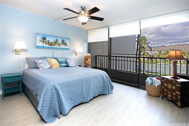 bedroom featuring light hardwood / wood-style flooring and ceiling fan