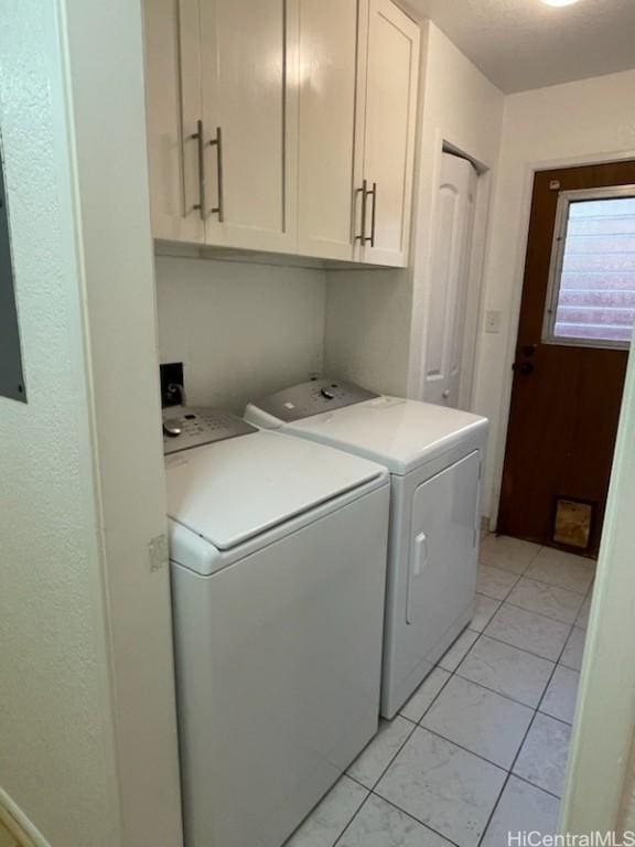 washroom featuring cabinets and independent washer and dryer