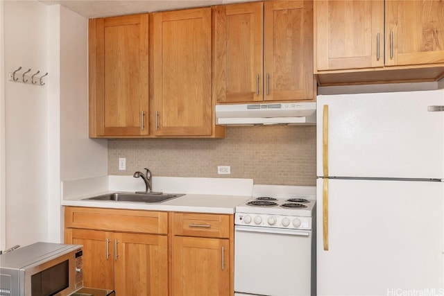 kitchen featuring white appliances, tasteful backsplash, and sink