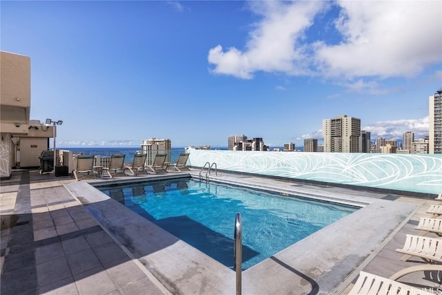 view of pool with a water view