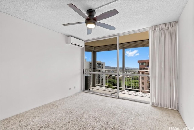 spare room featuring a wall mounted AC, ceiling fan, expansive windows, and light colored carpet