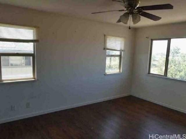 spare room with ceiling fan and dark hardwood / wood-style floors