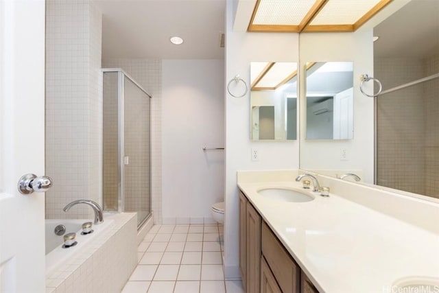 full bathroom featuring a skylight, vanity, plus walk in shower, tile patterned flooring, and toilet