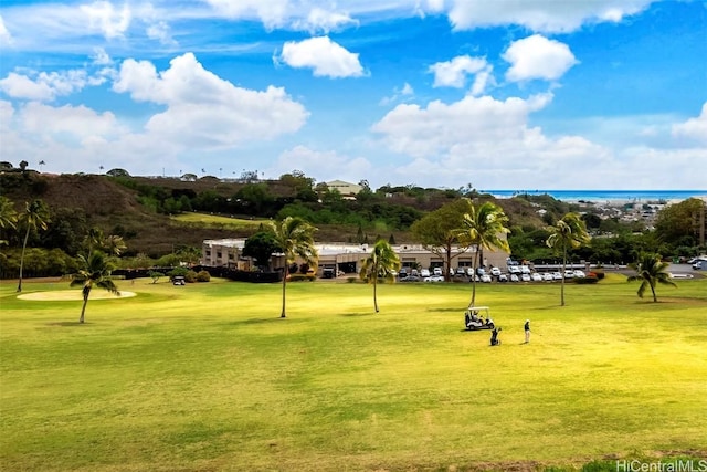 view of home's community featuring a yard and a water view