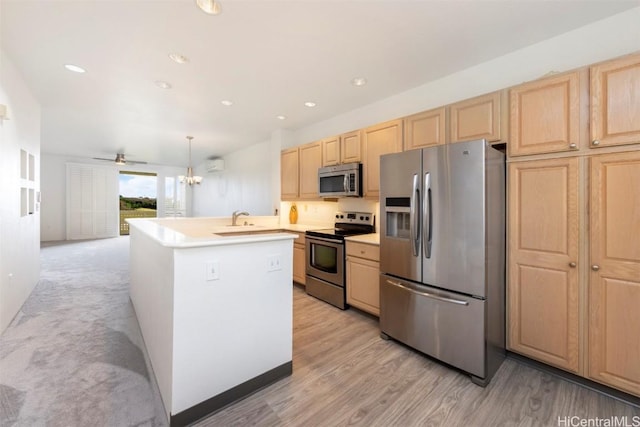 kitchen featuring light brown cabinets, sink, hanging light fixtures, ceiling fan, and appliances with stainless steel finishes