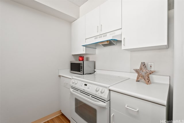 kitchen featuring white cabinets, light hardwood / wood-style floors, and electric stove