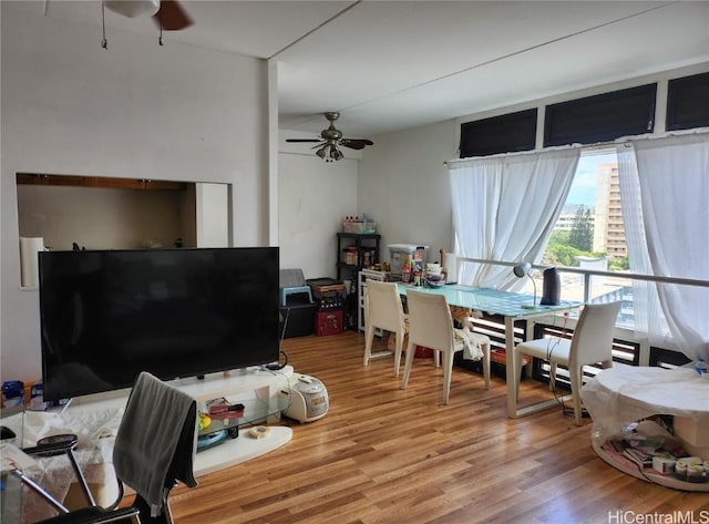 living room with ceiling fan and wood-type flooring