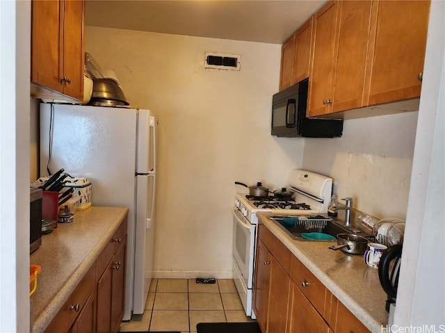 kitchen with light tile patterned floors and white appliances