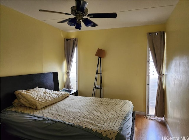 bedroom with ceiling fan and wood-type flooring