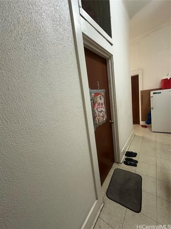 hallway with light tile patterned floors