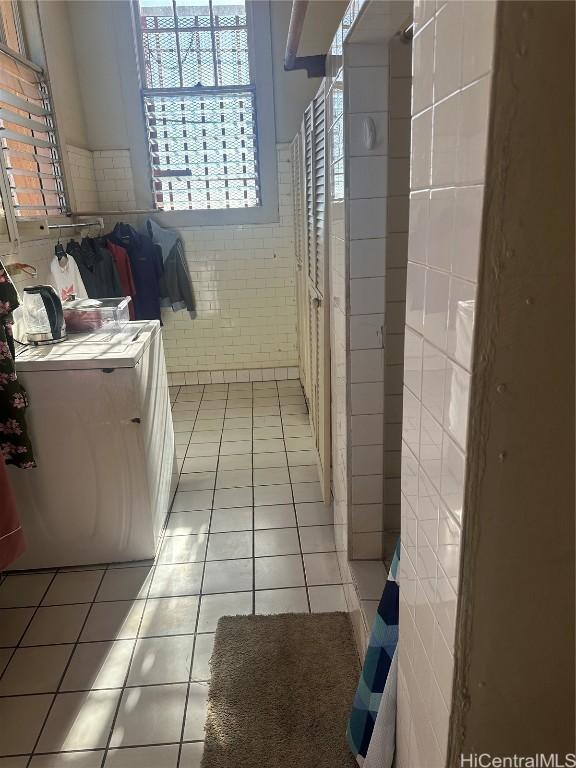 bathroom with tile patterned floors and tile walls