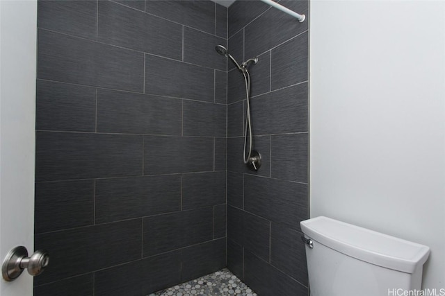 bathroom with toilet and tiled shower