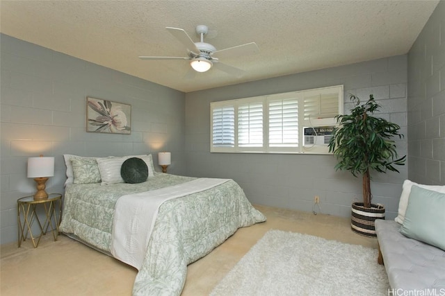 bedroom with ceiling fan, cooling unit, and a textured ceiling