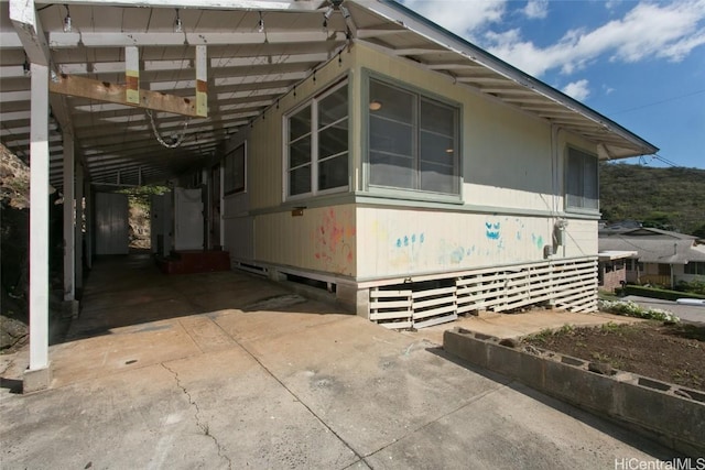 view of home's exterior featuring a carport