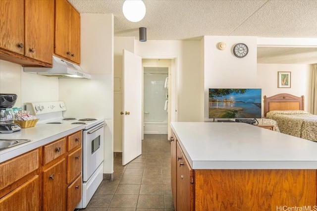 kitchen featuring dark tile patterned flooring, a kitchen island, electric stove, and a textured ceiling