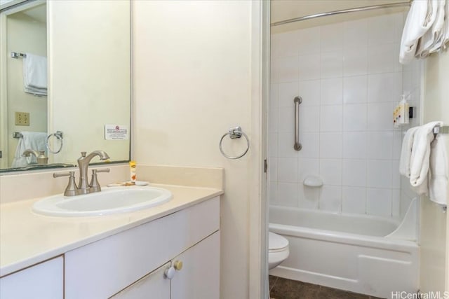 full bathroom featuring toilet, vanity, and tiled shower / bath