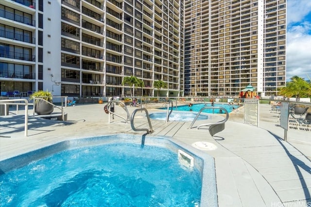 view of pool featuring a patio area and a community hot tub