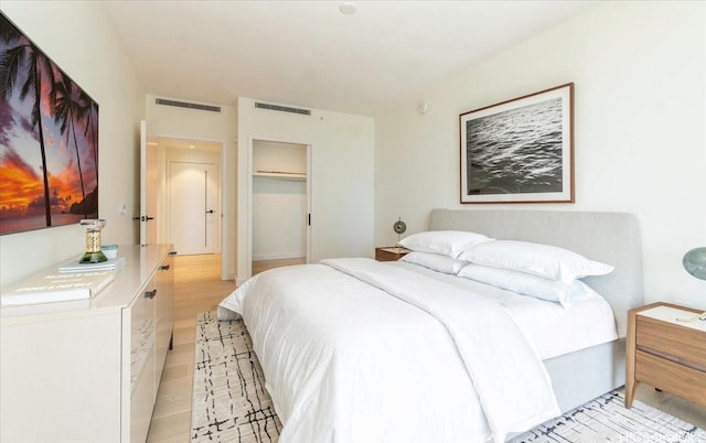 bedroom with a closet and light hardwood / wood-style flooring