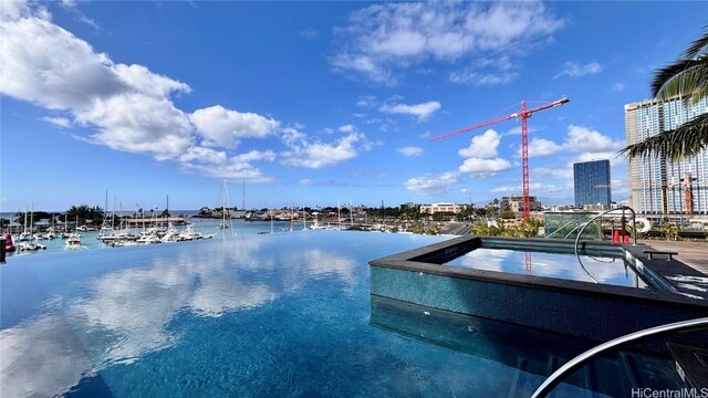 view of swimming pool featuring a water view