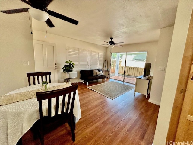 living room featuring hardwood / wood-style floors and ceiling fan