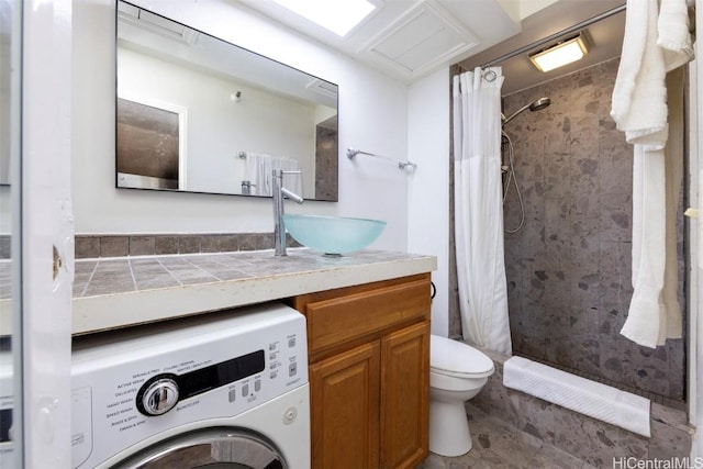 bathroom with a shower with curtain, vanity, washer / clothes dryer, and toilet