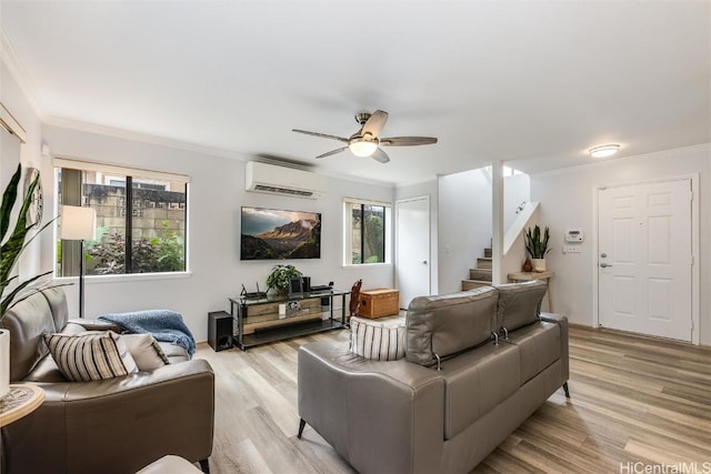 living room with plenty of natural light, light hardwood / wood-style floors, and an AC wall unit