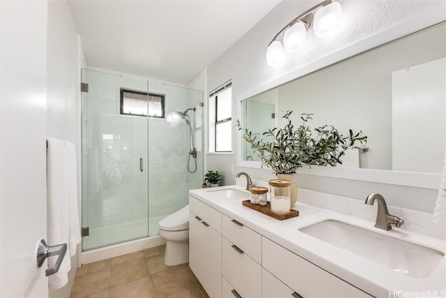 bathroom with tile patterned flooring, vanity, toilet, and a shower with shower door