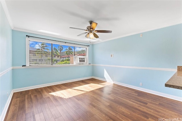 empty room featuring hardwood / wood-style flooring, ceiling fan, and crown molding