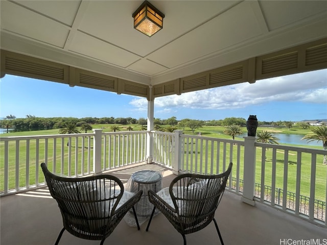 sunroom / solarium featuring a water view