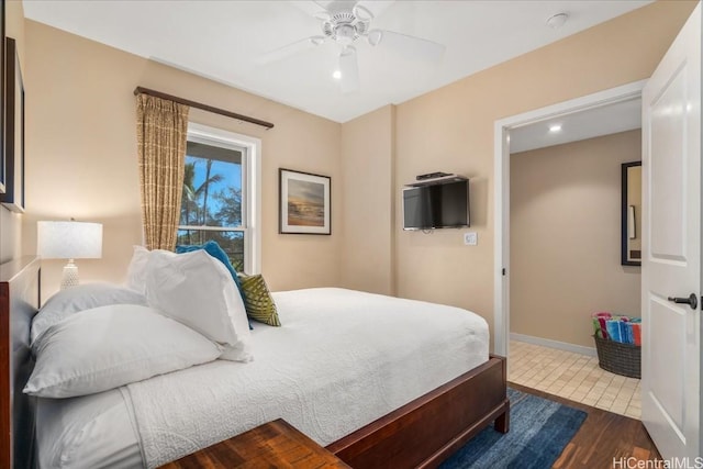 bedroom with dark hardwood / wood-style flooring and ceiling fan