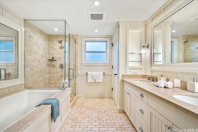 bathroom featuring vanity and shower with separate bathtub