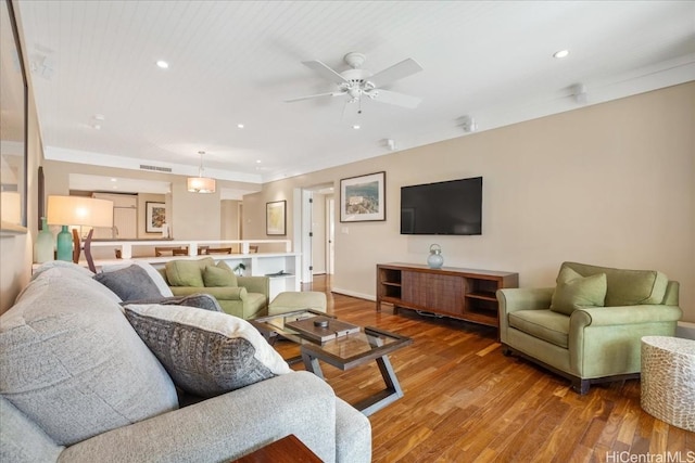 living room featuring hardwood / wood-style floors and ceiling fan