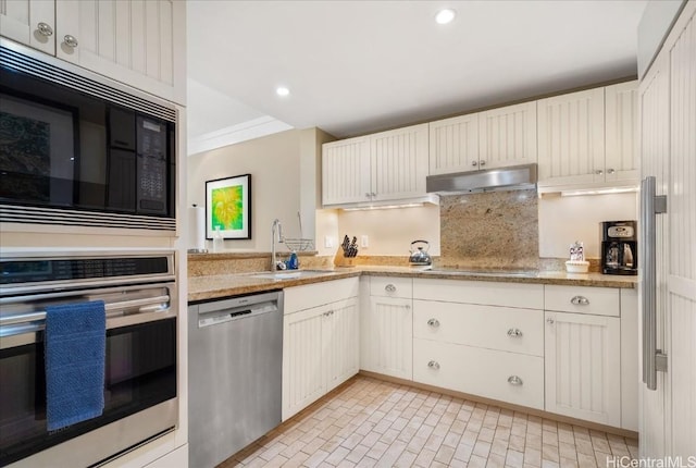 kitchen featuring sink, backsplash, appliances with stainless steel finishes, white cabinets, and ornamental molding