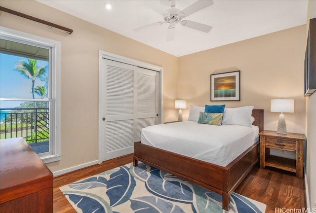 bedroom featuring ceiling fan, a closet, and dark wood-type flooring