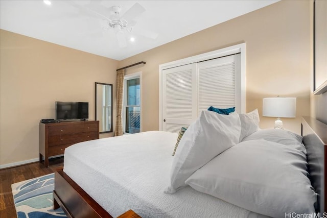 bedroom with ceiling fan, dark hardwood / wood-style floors, and a closet