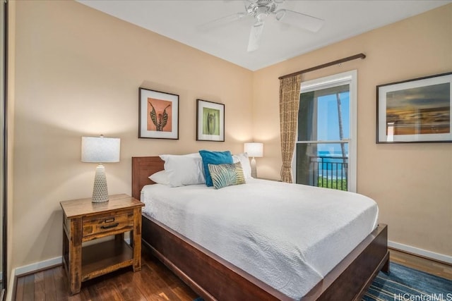 bedroom with dark hardwood / wood-style flooring and ceiling fan