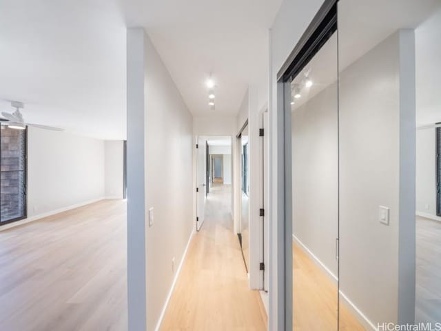 corridor with light wood-type flooring