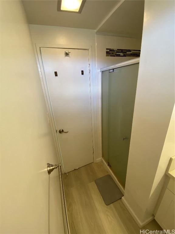 bathroom featuring hardwood / wood-style floors and walk in shower